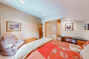 a bedroom with a large bed and a chair at Fairway View in McCall