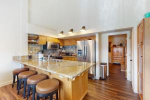 a kitchen with a large island with bar stools at Eagle's Perch in Shaver Lake