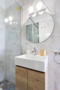 a bathroom with a white sink and a mirror at EK El Risco Candelaria in Candelaria