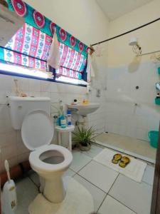 a bathroom with a toilet and a sink at Palm Paradise Loft in Diani Beach