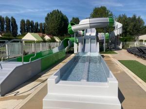 a water park with a water slide in a park at Mobil-home Ouistreham in Ouistreham