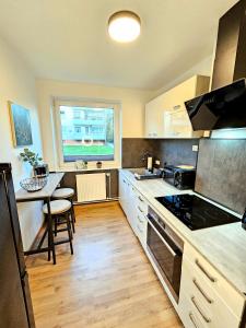 a kitchen with a table and a stove top oven at Fewo Honey, ganze Ferienwohnung mit 3 Schlafzimmern, Waschmaschine,Businesswohnung, Monteurzimmer in Salzgitter +4 photos