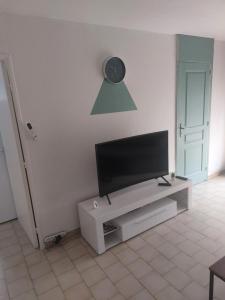 uma televisão de ecrã plano numa bancada de televisão numa sala de estar em T2 Montpellier plein sud clim wifi terrasse de 16m2 em Montpellier