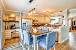 een keuken met een houten tafel en blauwe stoelen bij Spacious Dundalk Townhome 8 Mi to Inner Harbor! in Dundalk