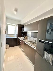 Kitchen o kitchenette sa Bright modern apartment with full amenities and parking with 24hs security