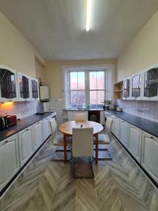a large kitchen with a table and chairs in it at Apex Haymarket Station Apartment in Edinburgh