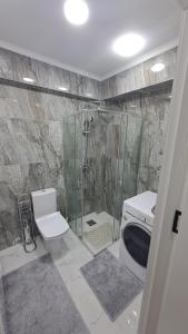 a bathroom with a shower and a toilet and a sink at AIRPORT 24&24 CAR PARKING in Chişinău +62 photos