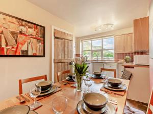 a dining room with a table with plates and wine glasses at 3 Bed in Borrowdale SZ148 in Grange