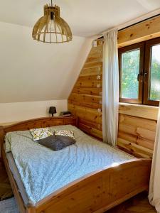 a bedroom with a wooden bed in a room at Zamojskie Bieszczady in Stary Zamość +11 photos