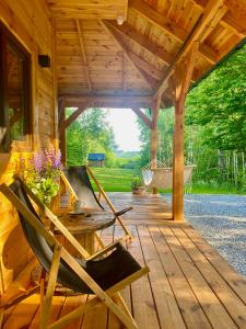 a wooden pavilion with a hammock on a deck at Zamojskie Bieszczady in Stary Zamość +11 photos