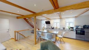 a kitchen with a table and chairs in a room at Lillis Cottage in Goslar