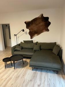a living room with a couch and a table at Apartmánový dům Jánský sen in Janske Lazne