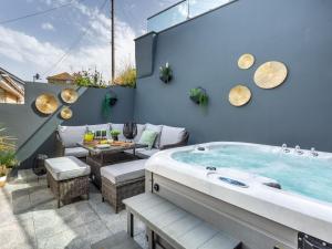 a hot tub sitting on top of a patio with a table at 3 Bed in Ilfracombe 48133 in Ilfracombe