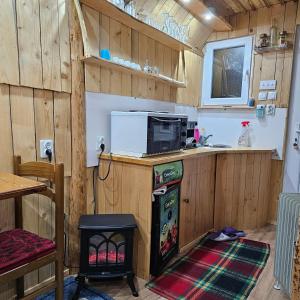 a kitchen with a refrigerator and a microwave at Planinska Bajka pogodna za dnevne boravka i one koji se vole in Olovo