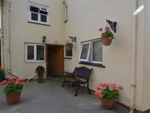 a house with flower pots on the side of it at 2 Bed in Wells VESPE in Wells