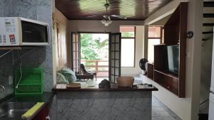 a kitchen with a sink and a counter top at Apê aconchegante - 6 pessoas in Bertioga