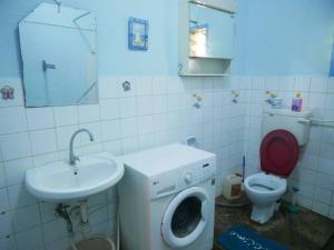 a bathroom with a washing machine and a sink at Masula Homes in Mombasa