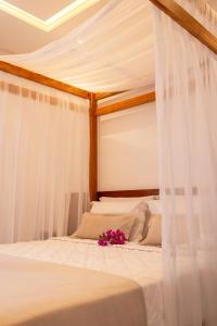 Llit o llits en una habitació de Vila Gallina Pousada