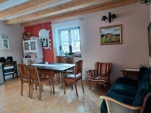 a kitchen and dining room with a table and chairs at Trzy Strumyki in Kąty Bystrzyckie