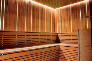 a sauna with wooden benches and lights on the wall at Flatbook - City Center SPA Apartments Deo Plaza in Gdańsk