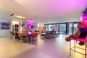 a living room with a teddy bear sitting on a chair at Housi Paulista in Sao Paulo