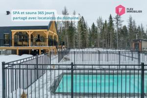 a swimming pool with a gazebo in the snow at Casa de Campo / Luxury, Comfort & SPA near Quebec in Valcartier Station