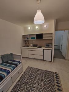 a living room with a bed and a kitchen at Balkan-Inn Apartments in Belgrade