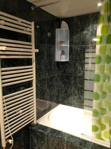 a black tiled bathroom with a sink and a shower at Cozy apartment for 6 people - Port Aventura in Vila-seca