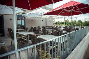 a restaurant with tables and chairs and umbrellas at Hotel Central Vis a Vis in Mainz