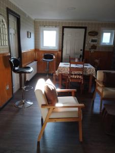 a living room with a couch and chairs and a table at Cabañas Marina del Sur 1 in Puerto Natales