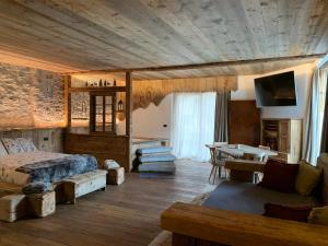 a bedroom with a bed and a table in a room at B&B da Lucia 2 Bormio in Valdisotto