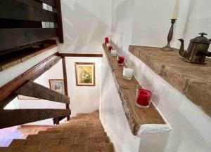 a stairway with glasses of red wine on it at La Casina di Nada in Massa Martana