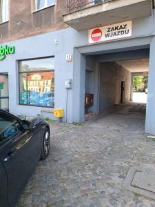 a car parked in front of a garage at Jungle Rooms in Gdańsk