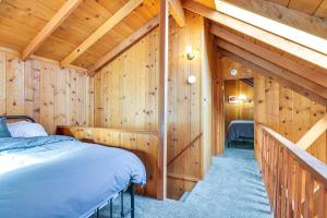 a bedroom with a bed in a wooden cabin at Cozy Mi-Wuk Village Cabin 18 Mi to Dodge Ridge! in Mi-Wuk Village