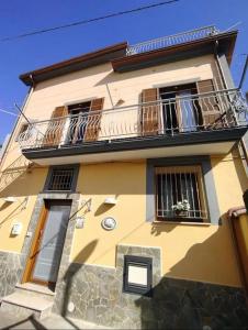 a yellow building with a balcony and a window at Casadduoglio home costa d'Amalfi in Vietri sul Mare