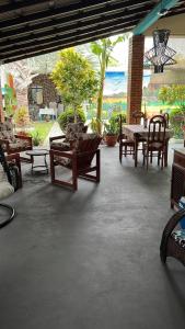 a patio with chairs and tables and a table and chairs at Pousada das Flores. in Boa Vista