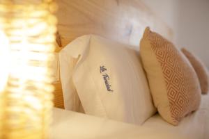 a pile of pillows sitting on a bed at La Trinidad Córdoba in Córdoba