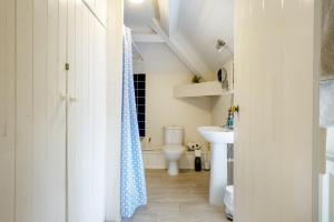 a bathroom with a toilet and a sink at White Lodge Haughton Castle in Hexham