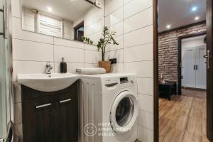 een badkamer met een wasmachine en een wastafel bij Happy Day - Happy Apartamenty Mielec in Mielec
