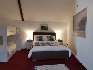 a bedroom with a large bed in a room at Skipton House Annex in Thirsk
