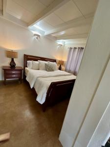 a bedroom with a large bed with white sheets and pillows at One Bedroom Apartment at Rancho Rillito in Tucson