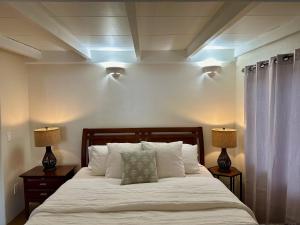 a bedroom with a white bed with two lamps at One Bedroom Apartment at Rancho Rillito in Tucson