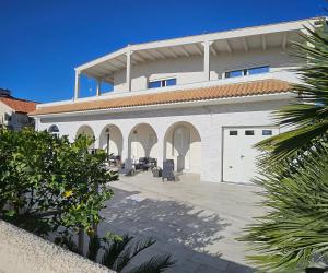 a large white building with a white garage at Villa ANNY in Avola