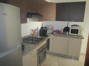 a kitchen with a stove and a microwave at Modern Apartment Horizon with Great Front View, Casablanca in Casablanca