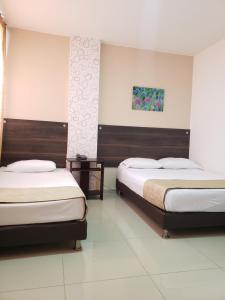 Postel nebo postele na pokoji v ubytování Hotel Suite Center Pereira