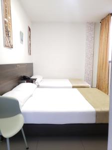 Postel nebo postele na pokoji v ubytování Hotel Suite Center Pereira