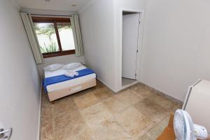 Cama ou camas em um quarto em Wafeh Pampulha Suítes