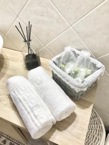 a wooden table with two towels and a basket on it at Casa di Riccardo in Savona