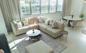 a living room with a couch and a table at Downtown Oasis, Burj Khalifa Views, Luxury Amenities in Dubai