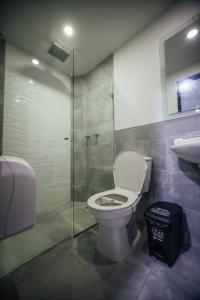 a bathroom with a toilet and a glass shower at Hotel Panorama Medellín in Medellín